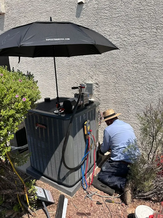 HVAC technician performing outdoor AC maintenance in Marysville